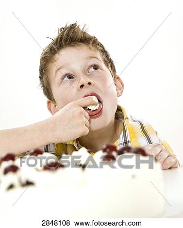 Boy having pastry View Large Photo Image Stock Photo - Boy having pastry . Fotosearch