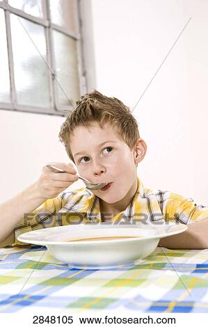 Boy having soup and thinking View Large Photo Image Stock Photography - Boy having soup and thinking . Fotosearch