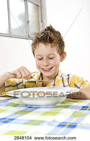 Picture - Boy having soup . Fotosearch