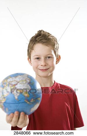 Stock Photograph - Boy holding globe and smiling . Fotosearch
