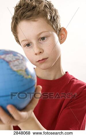 Boy holding globe View Large Photo Image Stock Photo - Boy holding globe . Fotosearch