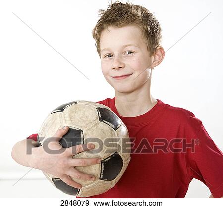 Boy holding soccer ball and smiling View Large Photo Image Stock Photo - Boy holding soccer ball and smiling . Fotosearch