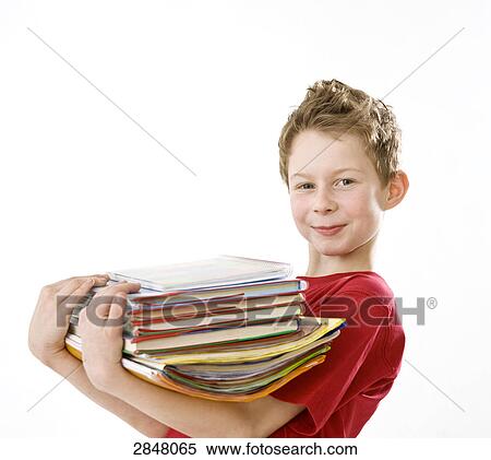 Stock Photography - Boy holding stack of books . Fotosearch