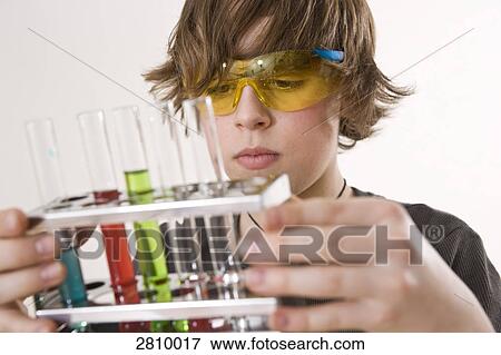 Boy holding test tube rack View Large Photo Image Stock Photo - Boy holding test tube rack . Fotosearch