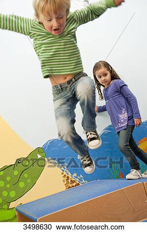 Boy jumping over boxes, low angle view View Large Photo Image Stock Image - Boy jumping over boxes, low angle view . Fotosearch