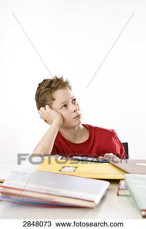 Boy leaning on books and thinking View Large Photo Image Stock Image - Boy leaning on books and thinking . Fotosearch