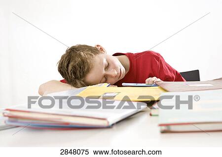 Stock Photography - Boy napping on books . Fotosearch