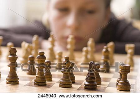 Stock Image - Boy playing chess . Fotosearch