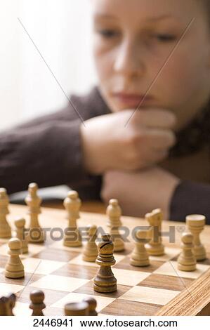 Stock Image - Boy playing chess . Fotosearch