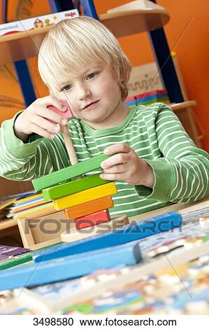 Boy playing with building blocks, low angle view View Large Photo Image Stock Image - Boy playing with building blocks, low angle view . Fotosearch