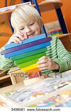 Boy playing with building blocks, low angle view View Large Photo Image Stock Image - Boy playing with building blocks, low angle view . Fotosearch