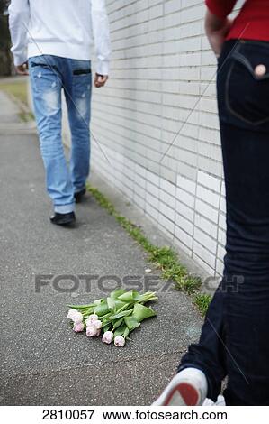 Boy walking with bunch of flowers behind him on road View Large Photo Image Stock Photo - Boy walking with bunch of flowers behind him on road . Fotosearch
