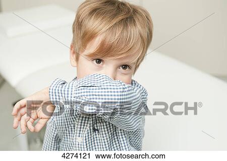 Stock Image - Boy with cough in medical practice . Fotosearch