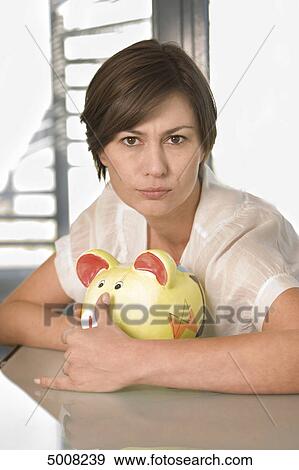 Brunette woman with piggy bank View Large Photo Image Stock Photo - Brunette woman with piggy bank . Fotosearch