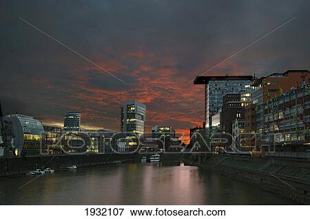 Stock Photo - Buildings lit up at dusk . Fotosearch