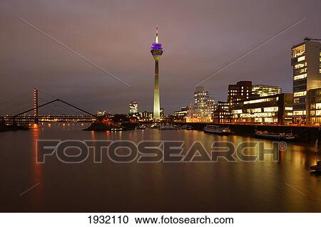 Buildings lit up at night View Large Photo Image Stock Image - Buildings lit up at night . Fotosearch