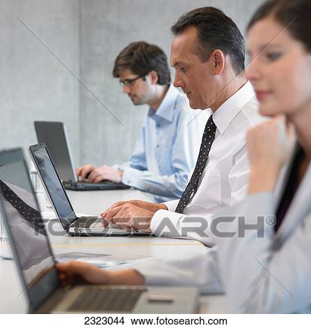 Business executives working in office View Large Photo Image Picture - Business executives working in office . Fotosearch