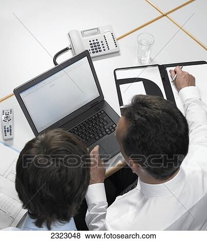 Stock Photo - Business executives working on laptop . Fotosearch