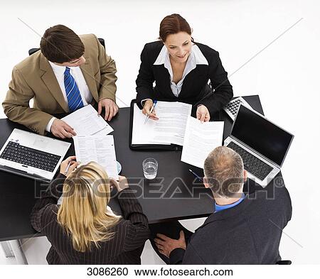 Business people sitting at a table, high angle view View Large Photo Image Stock Image - Business people sitting at a table, high angle view . Fotosearch