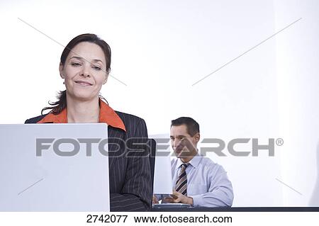 Business people working on laptops View Large Photo Image Stock Photo - Business people working on laptops . Fotosearch
