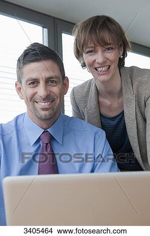 Business woman and business man smiling at camera View Large Photo Image Picture - Business woman and business man smiling at camera . Fotosearch