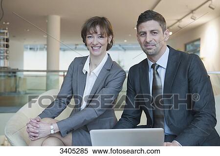 Business woman and business man smiling at camera View Large Photo Image Stock Photography - Business woman and business man smiling at camera . Fotosearch