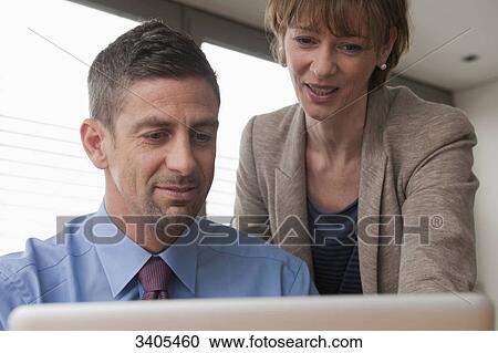 Business woman and business man using computer View Large Photo Image Stock Image - Business woman and business man using computer . Fotosearch