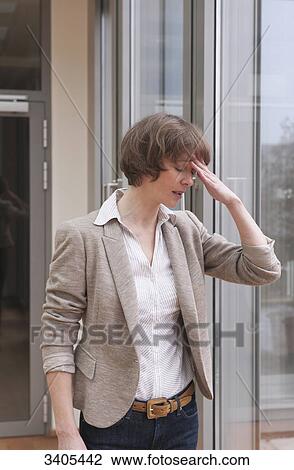 Business woman holding hand at forehead View Large Photo Image Stock Image - Business woman holding hand at forehead . Fotosearch