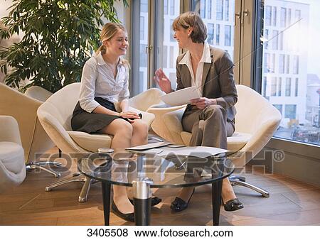 Business woman taking interview with a young woman View Large Photo Image Stock Photo - Business woman taking interview with a young woman . Fotosearch