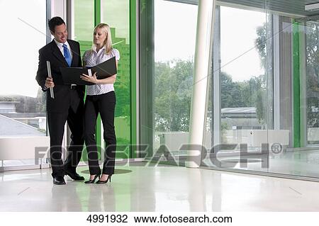 Stock Image - Businessman and woman talking . Fotosearch