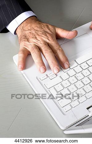 Stock Photograph - Businessman at laptop . Fotosearch
