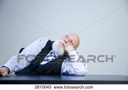 Businessman day dreaming in office View Large Photo Image Stock Image - Businessman day dreaming in office . Fotosearch