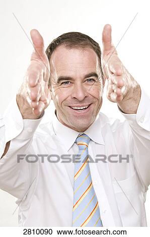 Stock Image - Businessman gesturing and smiling . Fotosearch