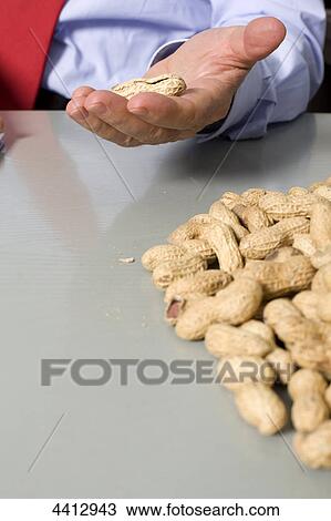 Businessman holding peanut in his hand View Large Photo Image Stock Image - Businessman holding peanut in his hand . Fotosearch