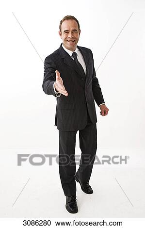 Businessman outstretching Hand for greeting, facing camera View Large Photo Image Stock Image - Businessman outstretching Hand for greeting, facing camera . Fotosearch