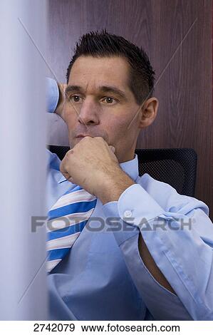 Businessman thinking in office View Large Photo Image Stock Photo - Businessman thinking in office . Fotosearch