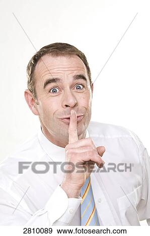 Businessman with finger on his lips View Large Photo Image Stock Photo - Businessman with finger on his lips . Fotosearch
