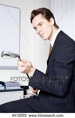Businessman with golf club View Large Photo Image Stock Image - Businessman with golf club . Fotosearch