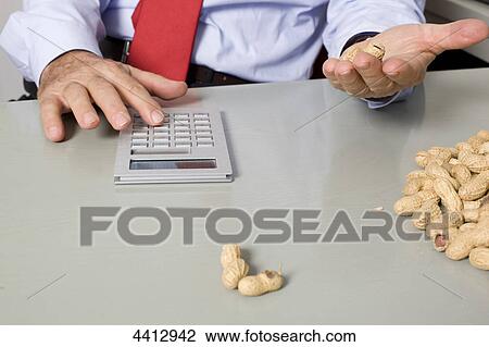 Businessman with peanut and calculator View Large Photo Image Stock Image - Businessman with peanut and calculator . Fotosearch