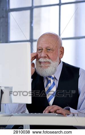 Businessman working on computer View Large Photo Image Stock Photo - Businessman working on computer . Fotosearch