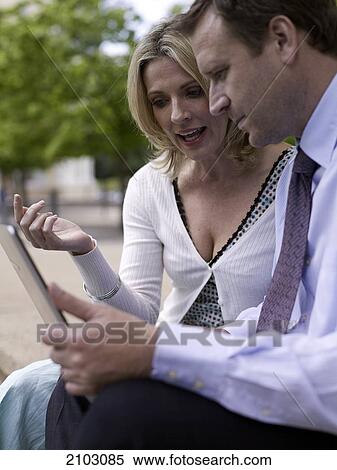 Businesswoman and businessman looking at laptop View Large Photo Image Stock Photography - Businesswoman and businessman looking at laptop . Fotosearch