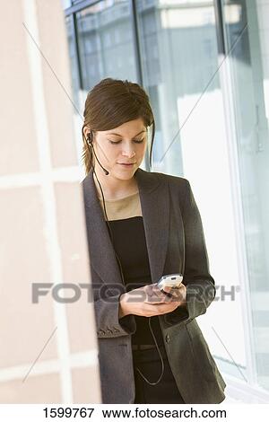 Businesswoman using mobile phone View Large Photo Image Stock Photo - Businesswoman using mobile phone . Fotosearch