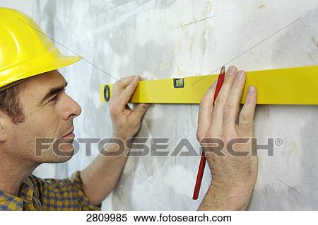 Carpenter marking on wall with spirit level View Large Photo Image Stock Photography - Carpenter marking on wall with spirit level . Fotosearch