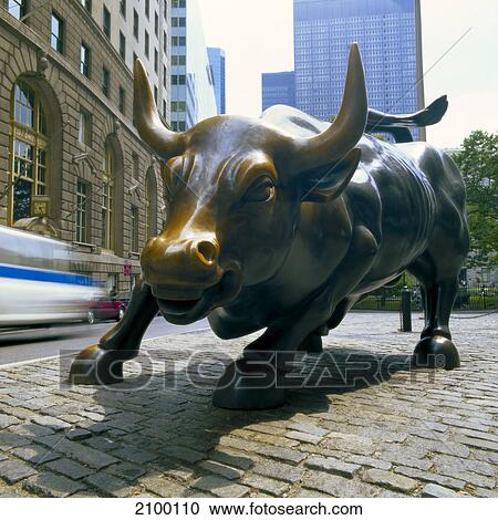 Stock Image - Charging bull statue in street, New York Stock Exchange, Wall Street, New York City, New York State, USA . Fotosearch