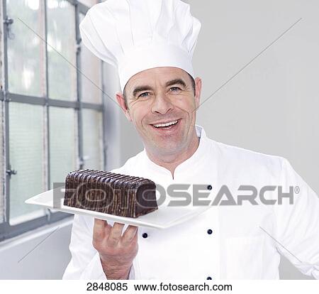 Chef holding chocolate pastry View Large Photo Image Stock Photography - Chef holding chocolate pastry . Fotosearch