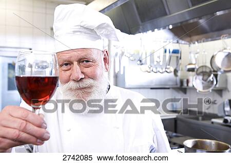 Chef holding glass of red wine View Large Photo Image Stock Photography - Chef holding glass of red wine . Fotosearch