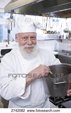 Chef smiling in commercial kitchen View Large Photo Image Stock Image - Chef smiling in commercial kitchen . Fotosearch