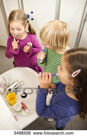 Children brushing their teeth, elevated view View Large Photo Image Stock Photo - Children brushing their teeth, elevated view . Fotosearch