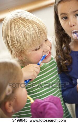 Stock Photography - Children brushing their teeth, elevated view . Fotosearch