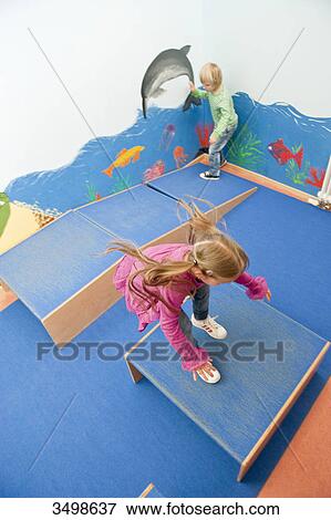 Children jumping over boxes, elevated view View Large Photo Image Stock Photo - Children jumping over boxes, elevated view . Fotosearch